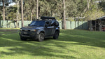 Charcoal Toyota Prado 250 with stainless and black Roar 4x4 platform roof rack fitted, rear three-quarter view