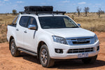 White Isuzu D-Max 2016-era dual cab with black Roar 4x4 platform roof rack fitted, front three-quarter, outback dirt
