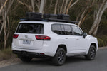 White Toyota LandCruiser 300 with black Roar 4x4 platform roof rack fitted, rear three-quarter, bush roadside